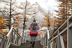 Asian woman female tourist climbing up the stairs leading to mount chenrezig