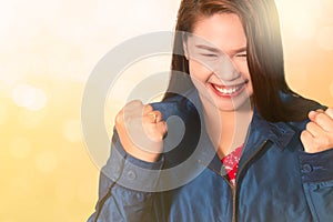 Asian woman with fists raised up gesture,  successful, celebrating victory,achievement and winning