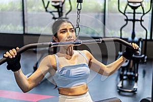 Asian woman fitness exercises at gym lat pulldown machine, Making an effort and training hard for fit body, Healthcare,