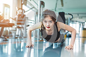 Asian woman fitness girl do pushing ups at fitness gym. Healthcare and Healthy concept. Training and Body build up theme.