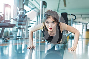 Asian woman fitness girl do pushing ups at fitness gym. Healthcare and Healthy concept. Training and Body build up theme.