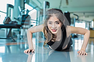 Asian woman fitness girl do pushing ups at fitness gym. Healthcare and Healthy concept. Training and Body build up theme.