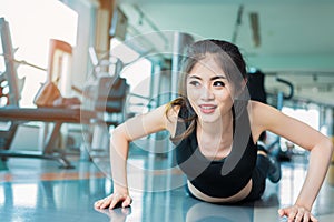 Asian woman fitness girl do pushing ups at fitness gym. Healthcare and Healthy concept. Training and Body build up theme.