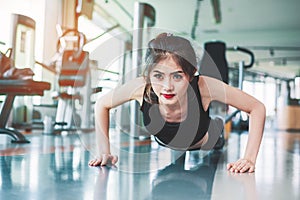 Asian woman fitness girl do pushing ups at fitness gym. Healthcare and Healthy concept. Training and Body build up theme. Strength