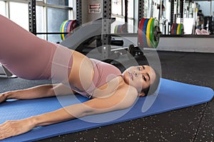 Asian woman in fitness sport gym. Woman exercising in the gym, keeping fit.