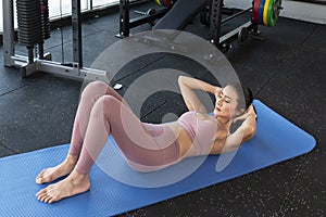 Asian woman in fitness sport gym. Woman exercising in the gym, keeping fit.