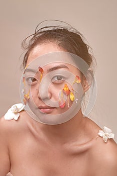 Asian woman with flowers on her face