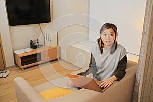 Asian woman forget somthing when she work at home by laptop