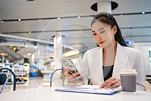 Asian woman freelance enjoy working and talking on mobile phone at cafe and people working from anywhere on digital device and