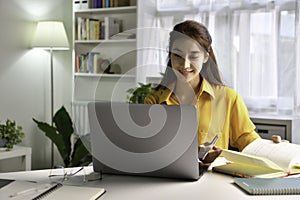 Asian woman freelancer working on computer at home. Attractive businesswoman studying online