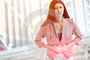 Asian woman front stomach painful sign of Ovarian Endometriosis and Chocolate Cyst syndrome photo