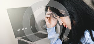 An asian woman getting anxiety and depression after checking news about global pandemic