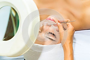 Asian woman getting a facial treatment in spa photo