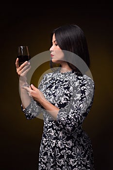 Asian woman with glass of red wine