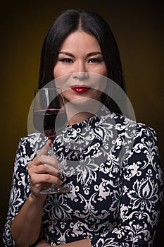 Asian woman with glass of red wine