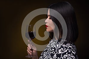 Asian woman with glass of red wine