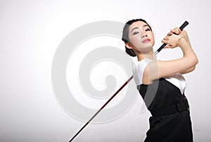 Asian woman golfing