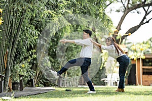 Asian Woman Grabbing and Catching Man shoulder and bracing the man to live with her