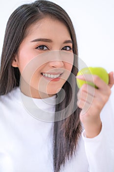 Asian woman with green apple