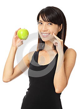 Asian woman with green apple and toothy smile