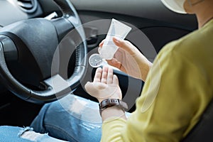 Asian woman in green shirt using hand sanitizer alcohol gel washing and cleaning her hands for prevent Covid-19 or Coronavirus