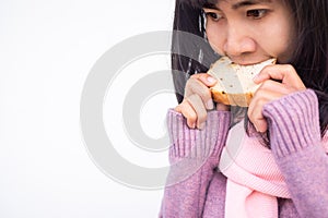 Asian woman with guernsey eating raisin bread starving and delicious in winter.