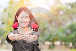 Asian woman hand hold give beautiful red heart sweet loving symbol of take care