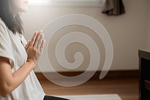 Asian woman with hand in praying buddha statue position,Copy space