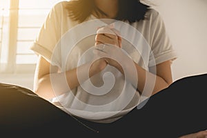 Asian woman with hand in praying position,Female prayer hands clasped together