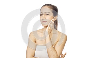 Asian woman with hand touching face