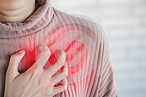 Asian woman hand touching her chest  having heart attack