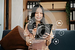 Asian Woman Hand using tablet ,laptop, and holding mobile phone with credit card online banking payment communication network,