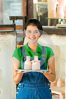 Asian woman with handmade pottery