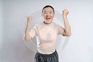 Asian woman happy confident showing her fist make a winning gesture