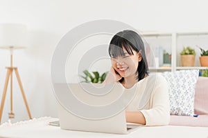 Asian woman happy smile using computer, laptop, Asia women working at home morning