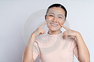 Asian woman happy smiling showing toothy smile