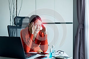 Asian woman have a migraine during working at home,Female suffering from headache