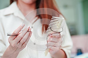 Asian woman have problem with long hair loss attach to comb brush