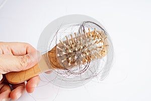 Asian woman have problem with long hair loss attach to comb brush