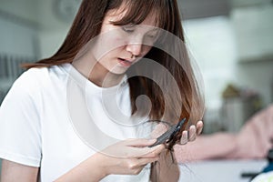 Asian woman have problem with long hair loss attach to comb brush