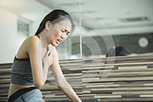 Asian woman having heart attack after workout.