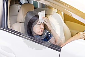 Asian woman having hot beacuse a heat wave in her car