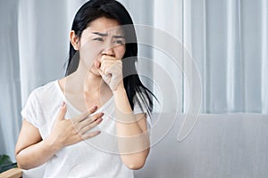 Asian woman having morning sickness feeling nausea and want to vomit photo