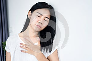 Asian woman having problem with asthma attacks and shortness of breath or difficulty breathing photo