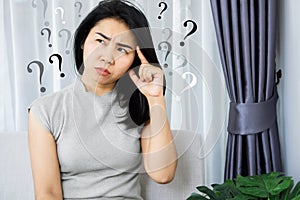 Asian woman having problem with Obsessive-Compulsive Disorder, forgetful and Alzheimer concept with question mark in her mind