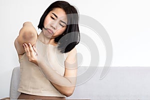 Asian woman having problem with skin condition dark elbow