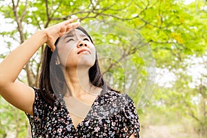 Asian woman having problem sunburn ,melasma, freckles on skin, hand cover her face to protect UV sunlight photo