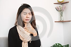 Asian woman having sore throat feeling sick in winter season