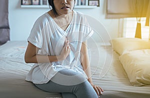 Asian woman having or symptomatic reflux acids photo