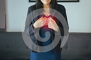 Asian woman having or symptomatic reflux acids,Gastroesophageal reflux disease,Because the esophageal sphincter that separates the photo